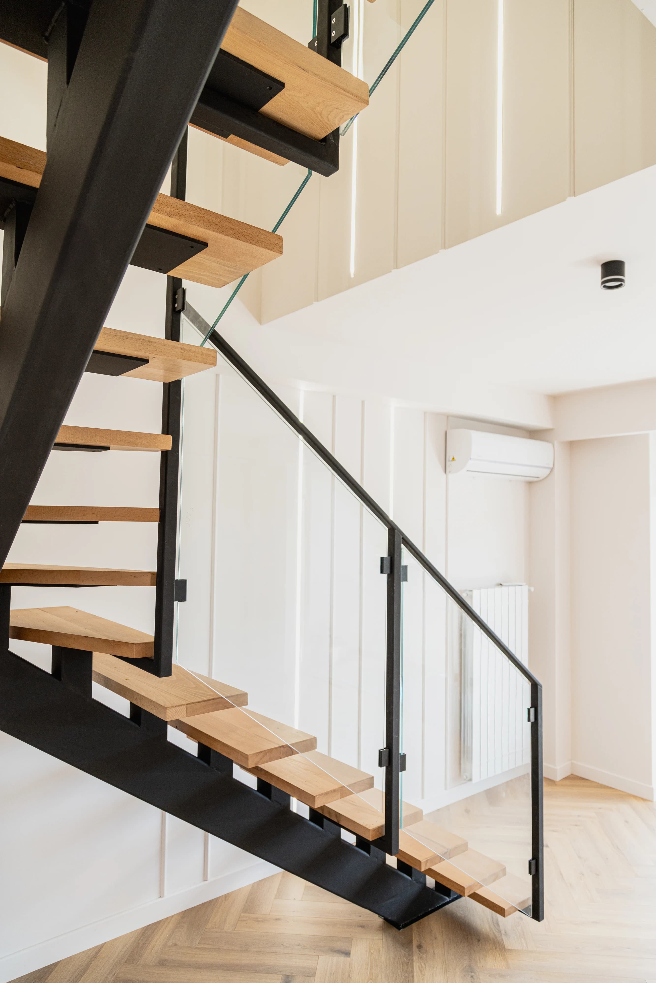 Oak and black steel staircase with a glass railing